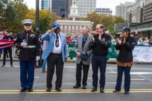 People applaud a Tuskegee Airman at the Veterans day parade
