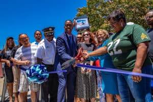 Council President Darrell Clarke, Police Captain Kpana Massaquoi and others cut the ribbon for the mural dedication