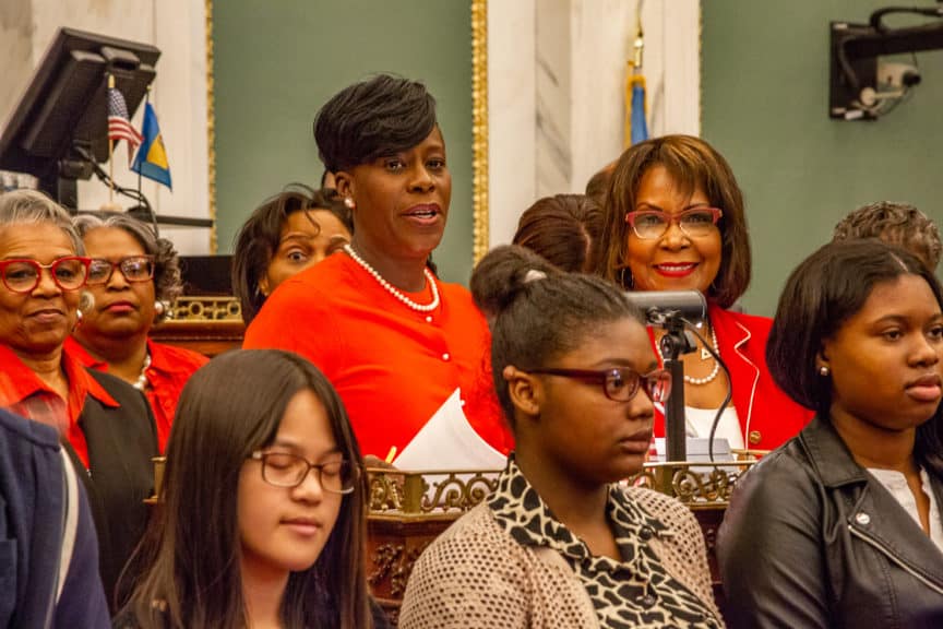 Councilmembers Cherelle Parker and Blondell Reynolds-Brown standing with women and young adults in a council session.