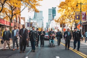 Councilmembers marching with veterans in the Veterans' day parade