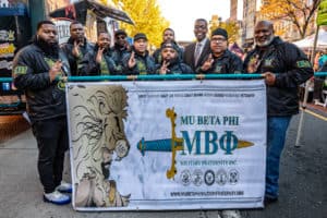 Members of Mu Beta Phi marching in the Veterans' day parade