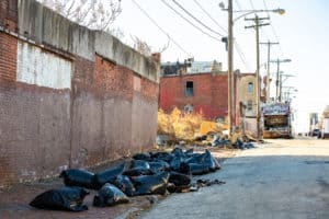 Bags full of debris that has been illegally dumped in the street