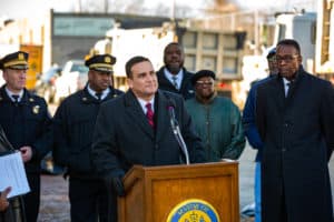 Council president Darrell Clarke and other city officials, outside near a dumping site, address the city's initiative to install 15 surveillance cameras to stop illegal dumping.