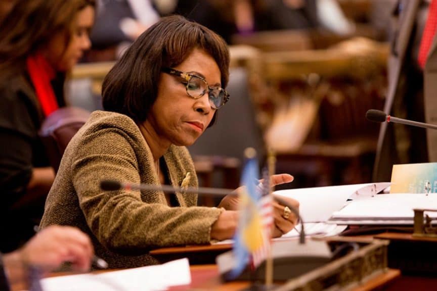 Councilmember Reynolds-Brown taking notes at a desk