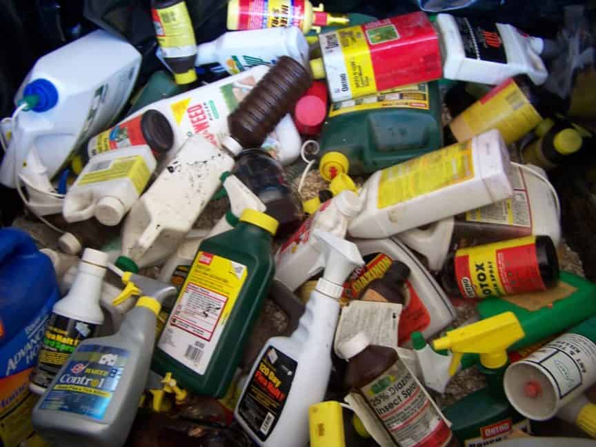A pile of used, empty bottles that once contained pesticides, weedkiller, and various hazardous chemicals