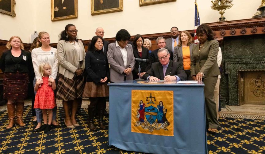 Mayor Kenney signing legislation with others looking on