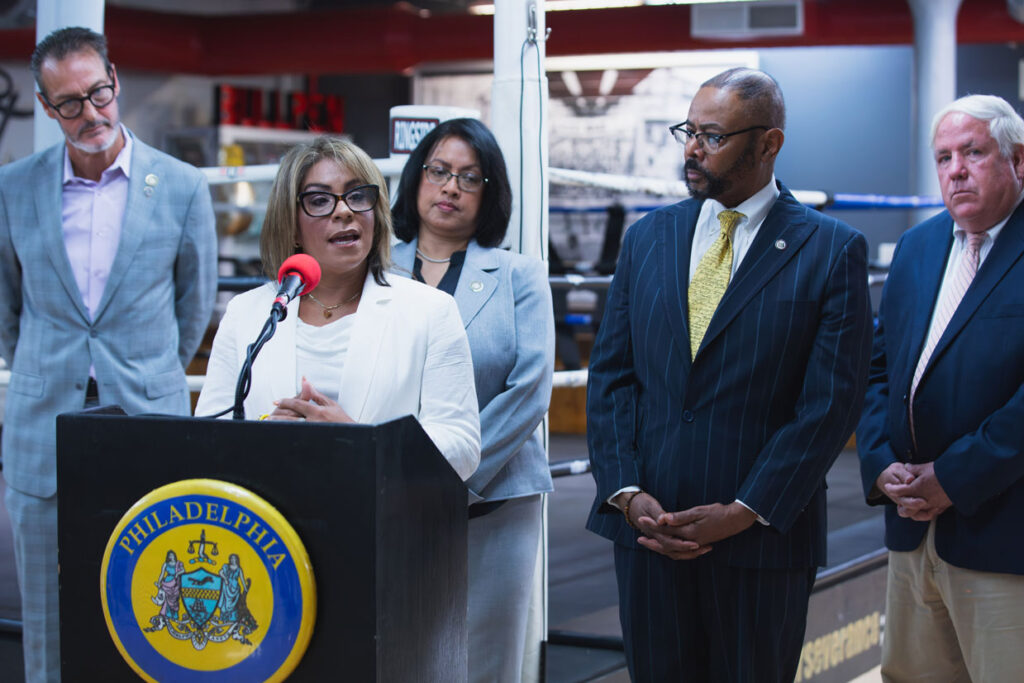 Quetcy-Lozada-speaking-at-podium